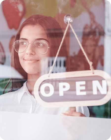 happy small business person changing closed to open