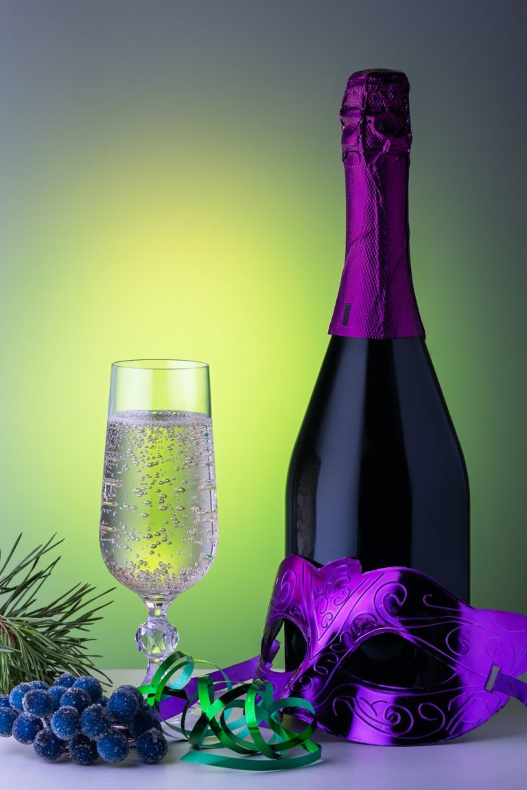 Christmas table with champagne and carnival mask