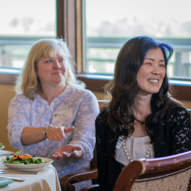 ApplewoodBusinessAssociation_LittleShoeStudios_19 2 ABA members clapping and smiling