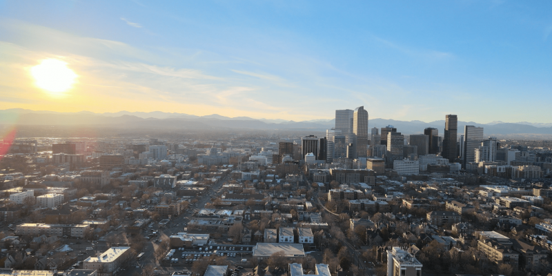 Screen Shot 2021-05-25 at 12.19.11 PM Denver skyline with mountains in background